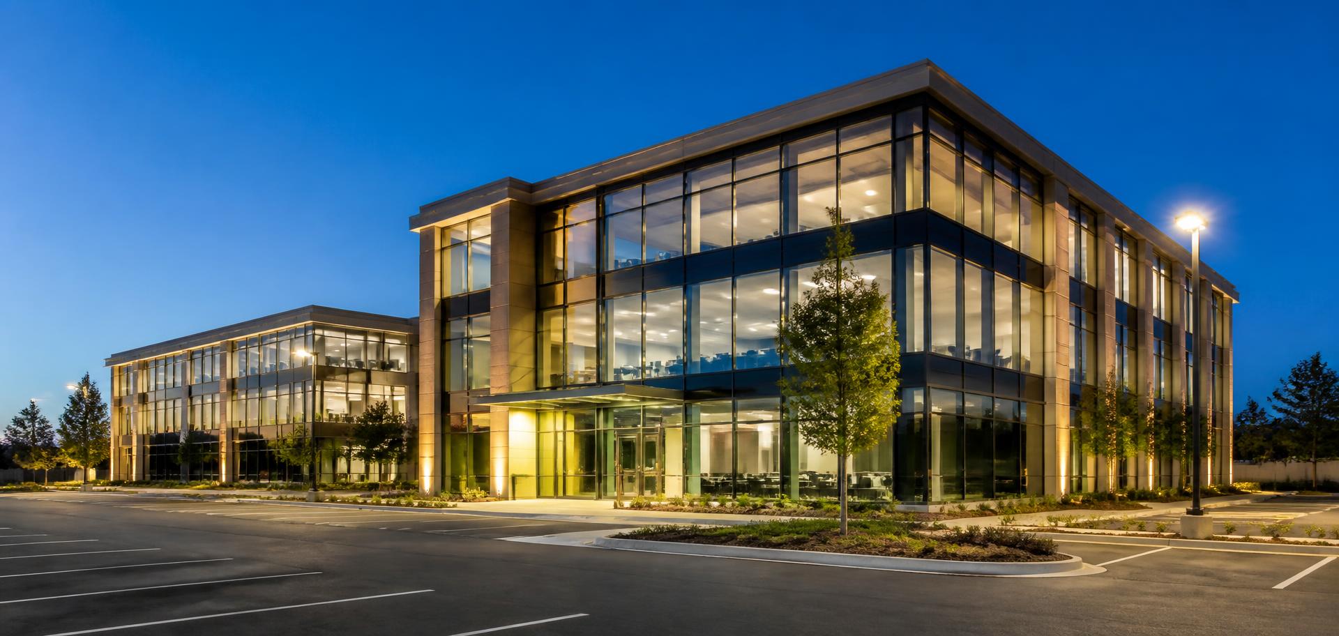 Modern commercial office building illuminated at dusk